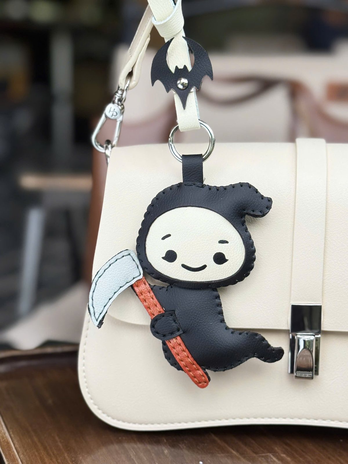 Little Reaper leather charm detail