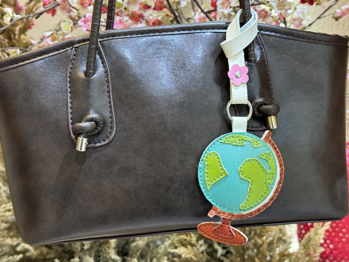 Globe leather charm detail