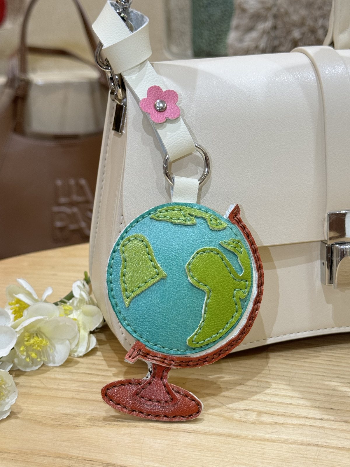 Globe leather charm on bag